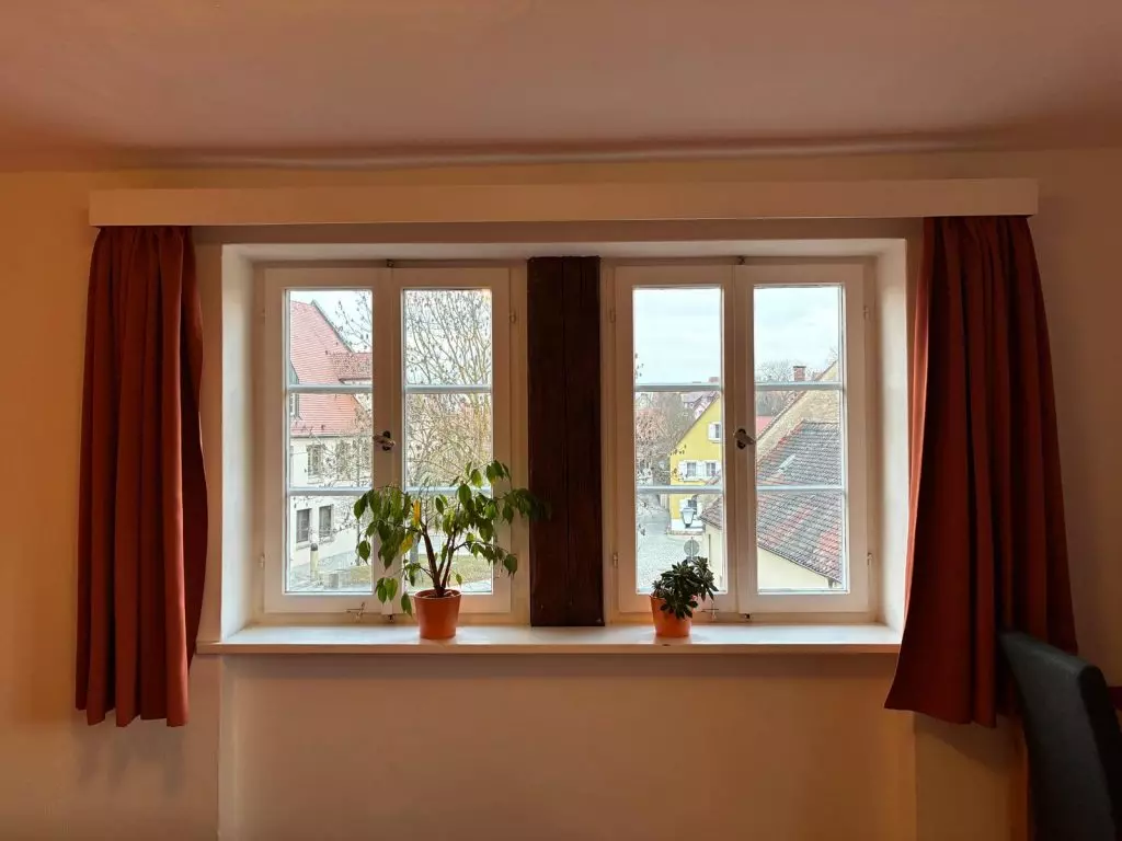 Fenster mit Pflanzen und Vorhängen